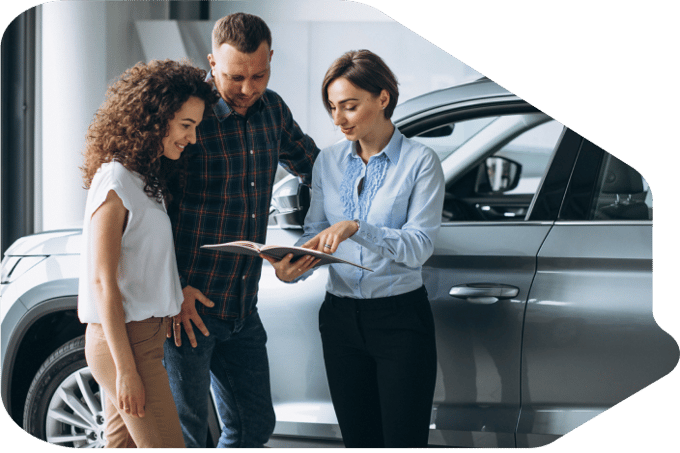 A couple talking to a car saleswoman