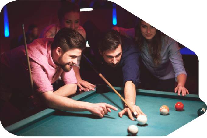 Three people watching as one man plays pool